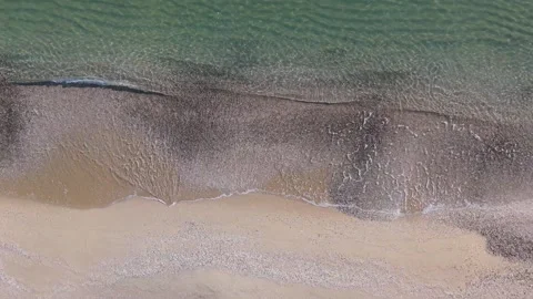 Aerial Top Down View of Waves Touching Sandy Beach Shore Stock Footage 325292405