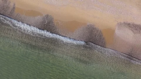 Aerial Top Down View of Waves Touching Sandy Beach Shore Stock Footage 325292406