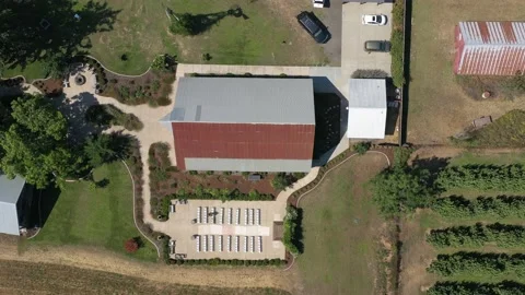 Aerial top down view of a wedding venue ceremony setup next to a barn at a farm 動画素材 174046944
