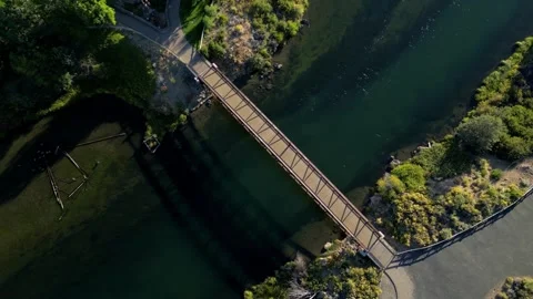 Aerial Top Down View While Rotating or Footbridge over Clear Water  Video stock 249749608
