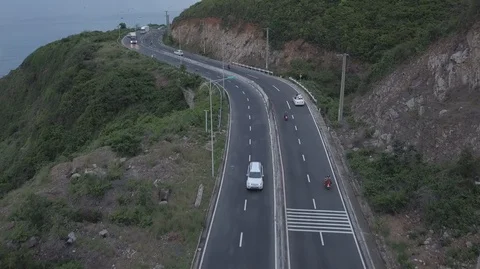 Aerial top down view of white convertible car driving along a winding coastal Stock-Footage 128364511