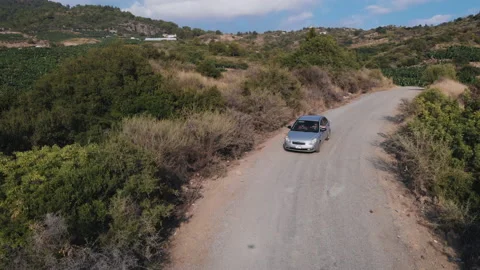 Aerial top down view , white car driving on the mountains road in the forest Stock Footage 130403778