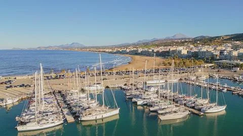 Aerial top down view of white yachts and sailboats anchored at Rethymno mar.. Stock Photos