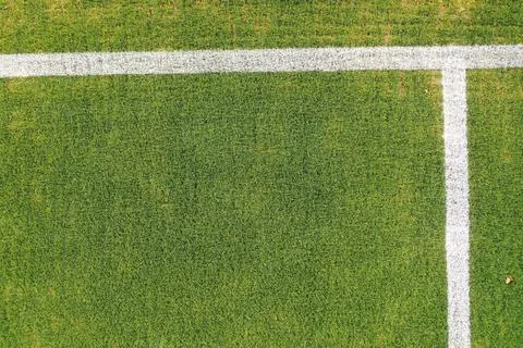 Aerial top down view of a white line on a green grass pitch Stock Photos