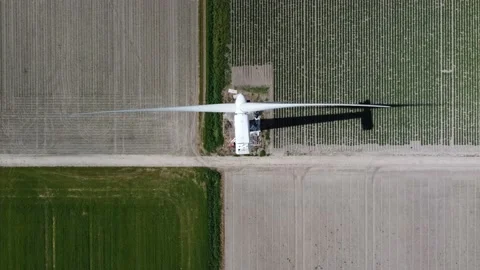 Aerial top down view of wind turbine which provides mechanical power 4k Stock Footage 158044040