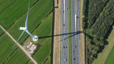 Aerial top down view of wind turbine and highway 4k Stock Footage 164556822