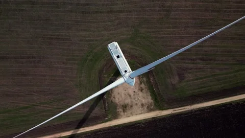Aerial top-down view of a wind turbine on farmland, showcasing the massive Stock Footage 289148693