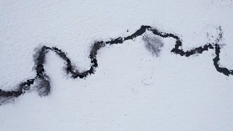 Aerial top down view of a winding black river in snow The Concept of Winter.. Stock-Footage 327288400