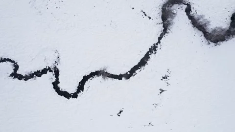Aerial top down view of winding stream in snow The concept of minimalism Stock-Footage 327469869