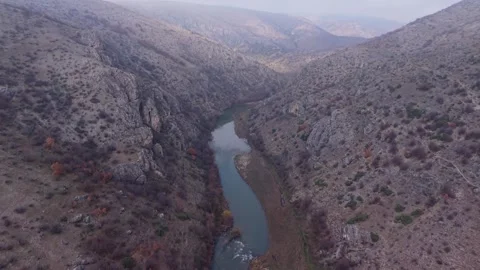 Aerial Top-Down View of Winding River Through Rugged Canyon Gorge Stock Footage 336286324