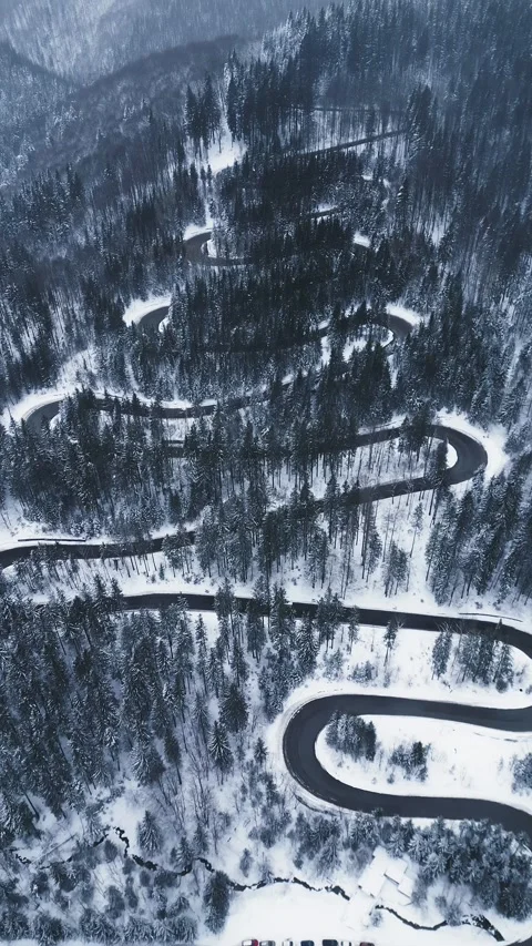 Aerial top down view of winter winding road in the forest, Transylvania, Romania Stock-Footage 232703649