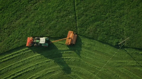 Aerial Top down View of Working Agricultural Harvester on Green Field. Stock Footage 64933145