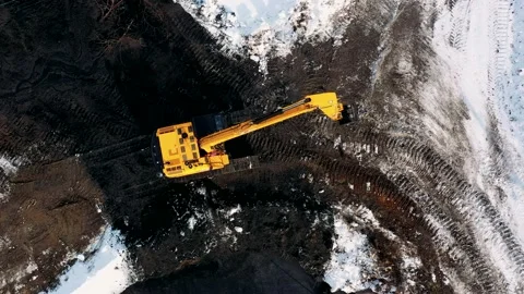 Aerial top down view of yellow hydraulic excavator working in quarries site Stock Footage 151353750
