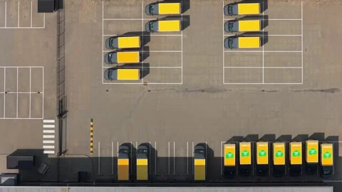 Aerial top down view of yellow delivery vans parking Stock Footage 341874993