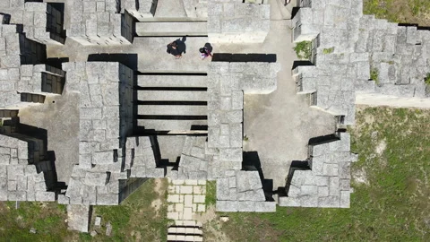 Aerial Top Down View of Young Couple Visiting Fortress Wall Tower Stock Footage 136985237