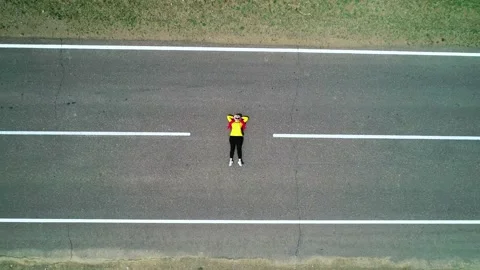 Aerial top down view of a young woman with pink hair braids and yellow jacket Stock Footage 187076523