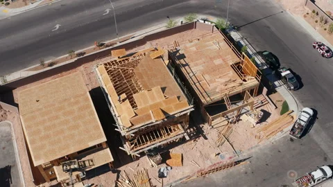 Aerial top down zoom out shot of workers building roofs in new house in Vegas Stock Footage 200517481