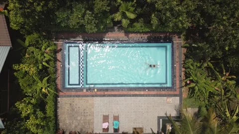 Aerial top down zoom out view tropical scene young woman swimming peacefull.. Stock Footage 309303457