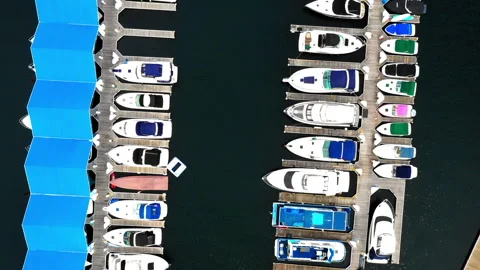 Aerial Top Forward Scenic View Of Nautical Vessels Moored At Harbor On River - Stock Footage 276239267