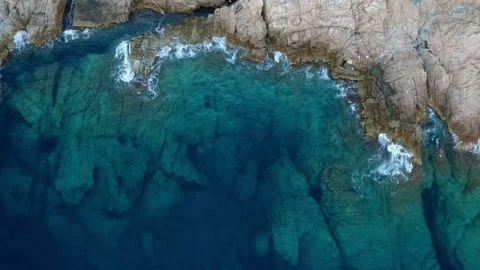 Aerial Top Lockdown: Blue waves splashing on rock formations-Begur, Spain Stock Footage 149229564