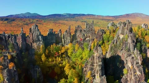 Aerial: top of mountain range dragon teeth overlooking colorful autumn forest Stock Footage 274155215