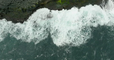 Aerial Top Panning Shot Of Patterned Waves Of Sea Splashing On Island - Faroe Stock Footage 219417690