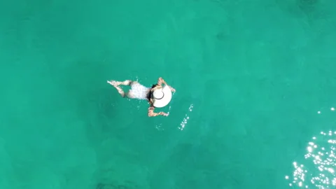 Aerial top shot breast stroke swimming in sea Stock Footage 168564314