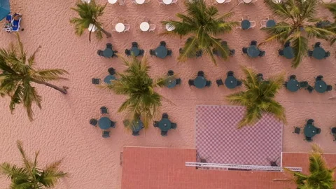 Aerial top shot of empty tables and sun loungers at beach in United Arab Stock Footage 133202637