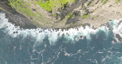 Aerial Top Upward Shot Of Patterned Sea Waves Splashing On Mountain - Faroe Stock Footage 219402559