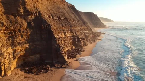 Aerial top view of an amazing sandy beach with a cliff in the Atlantic coast. Stock Footage 134834945