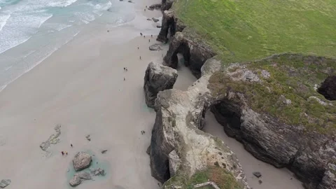 Aerial top view of beach rocks and green clifftop Stockbeeldmateriaal 343324072