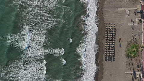 Aerial Top View Beach Umbrellas in Rows on Malaga Shore with Waves Spain Vidéo 336301366