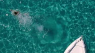 Aerial - Top View Of A Beautiful Young Woman Jumping From A Motor Boat Bow Stock Footage