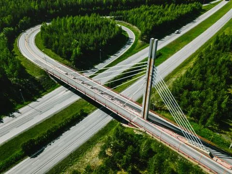 Aerial top view of cable-stayed Suspension bridge and Highway road with green Stock Photos