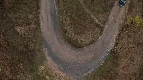 Aerial top view of car going on small road with tight bends Stock Footage 100687864