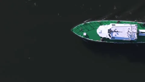 Aerial Top View of Cargo Ship with Green Deck Sailing on Dark Water Surface Stock Footage 315523371