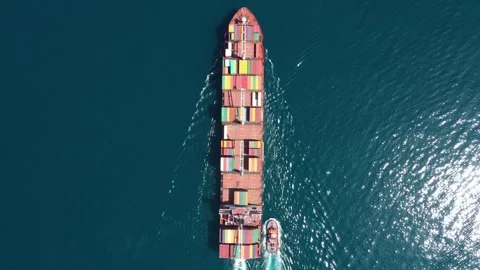 Aerial top view of cargo ship carrying container with contrail in ocean sea Stock Footage 336445698