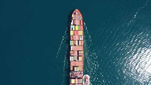 Aerial top view of cargo ship carrying container with contrail in ocean sea Video stock 336445706