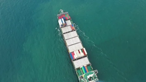 Aerial top view of cargo ship carrying container with contrail in ocean sea Stock Footage 336445730