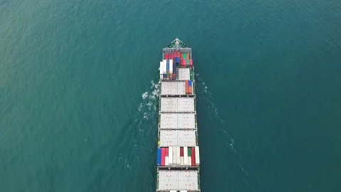 Aerial top view of cargo ship carrying container with contrail in ocean sea Stock Footage 336445739