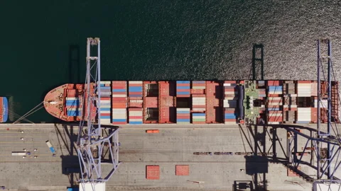 Aerial top view of a cargo ship loading containers at the port Stock Footage 345842955