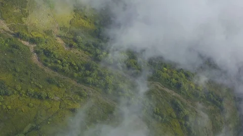 Aerial top view clouds float over the green mountains Stock Footage 125707283