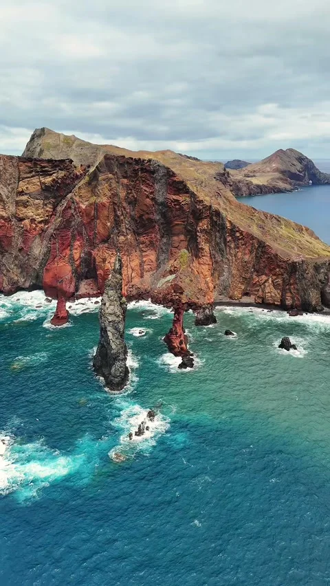 Aerial Top View of Coastal Cliffs and Rock Formations in the Ocean Stock Footage 323935814