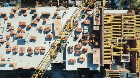 Aerial Top view on the construction of a multi-storey red brick house. Builders Video stock 152612947