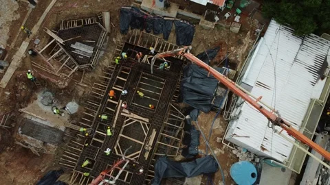 Aerial top view construction workers pouring concrete foundation Video stock 333283819