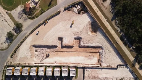 Aerial top view of construction zone reveals excavated pit building foundation Stock Footage 271369852