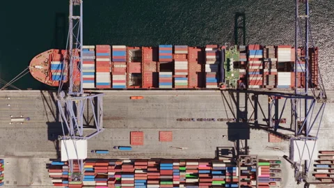 Aerial top view of a container ship loading at a commercial port Stock Footage 345843559