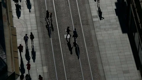 Aerial top view of crowd of unrecognizable people walking in street with shadows Video stock 89148010