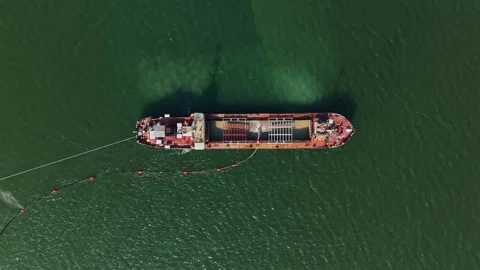 Aerial top view of dredging ship in green sea water Stock Footage 338187400