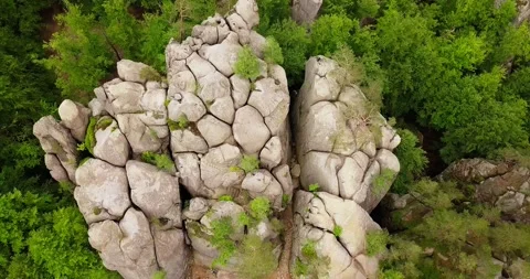 Aerial Top view from a drone on a cave city in a lonely rock among forest Video stock 134798367